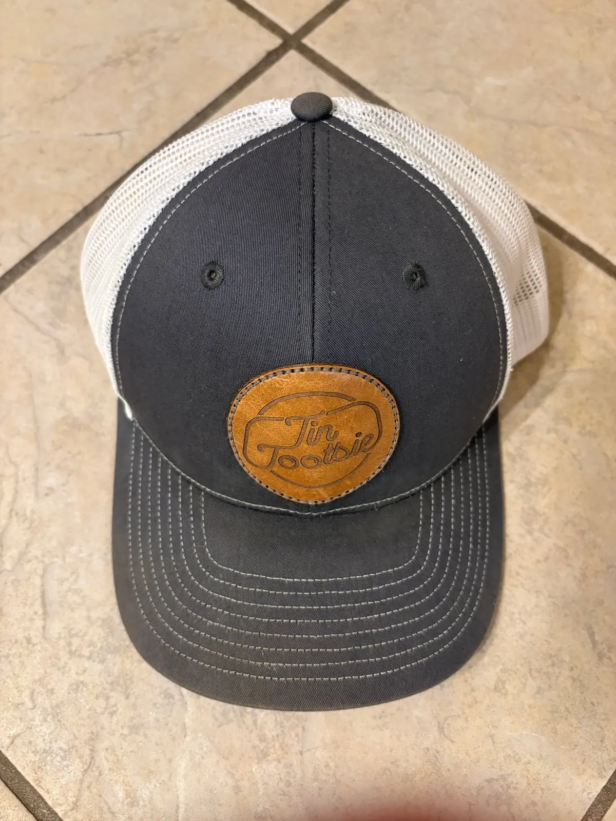 Retired grey Tin Tootsie trucker hat with leather patch